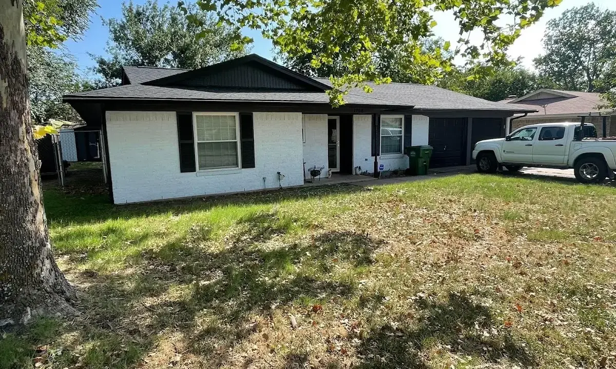 Professional roofing crew working on a residential roof in North Andover